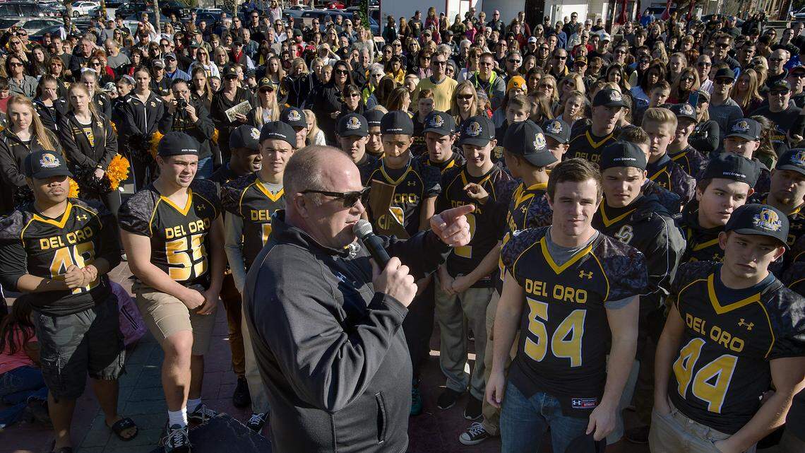 Golden Eagles then-coach Casey Taylor addresses a crowd during a parade and celebration rally honoring the Del Oro High School football team's 2015 state championship in Loomis in 2015. The team entered the playoffs as the No. 10 seed in the CIF Sac-Joaquin Section, which this week voted to reduce the playoff bracket from 12 teams to eight.