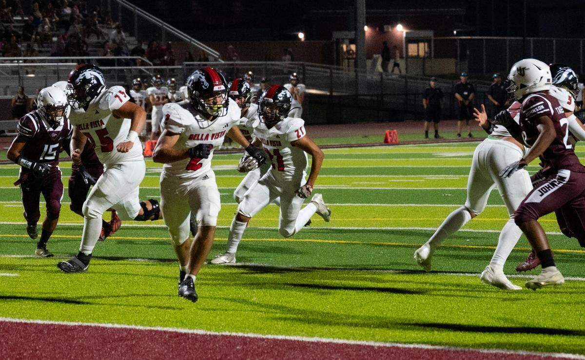 Bella Vista Broncos running back Mathew Bunney (21) is escorted into the end zone by guard Tyler Eland (75) and running back Nolan Bernhard (2) against the Hiram Johnson Warriors on Friday.