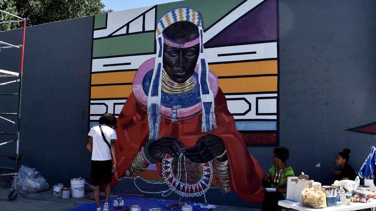 In this photo from the Sojourner Truth African Heritage Museum, a mural depicts a woman from southern Africa’s Ndebele tribe. Wide Open Walls asked museum founder and director Shonna McDaniels for a mural in Oak Park, and she brought youth artists from the museum to paint it with her.