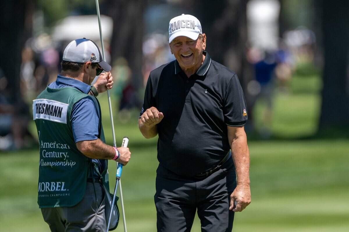 Former NFL quarterback Joe Theismann reacts with his caddie after finishing his round of golf during the American Century Championship celebrity tournament at Edgewood Tahoe Resort in Stateline, Nev., on Friday, July 11, 2025.