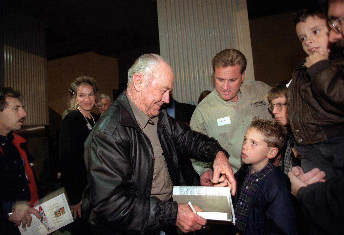 General Chuck Yeager signs autographs for the many invited guests to the opening of Aces Supper Club on Wednesday, Dec. 8, 1999. The club, located at 5325 Date Avenue near Madison Avenue, salutes the area’s aviation history when neighboring McClellan Air Force base dominated the economy of the Sacramento region. A replica of Yeager’s P-51 Mustang WWII era fighter hangs outside of the restaurant.
