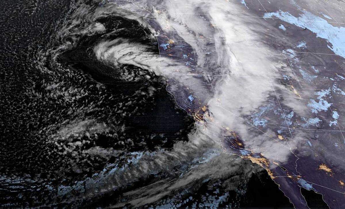 A large storm, being propelled by an “atmospheric river,” is seen over California in an image taken by NOAA’s GOES-WEST satellite on Wednesday, Jan. 27, 2021. Forecasters say the storm will continue to bring rain, snow, winds and more to California throughout Friday.