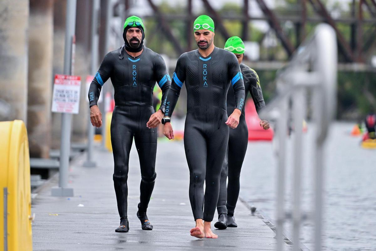 Triathletes walk on the ramp after finishing the swim portion during the Ironman California triathlon on Sunday in West Sacramento.