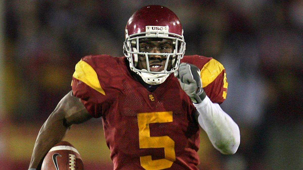 USC tailback Reggie Bush picks up yards in 2005 against Fresno State in Los Angeles.