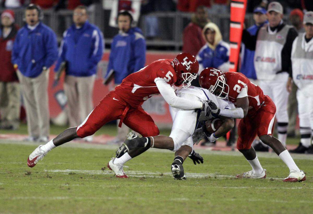 Tulsa Golden Hurricane wide receiver Brennan Marion, center, is tackled by Houston Cougars defenders in 2008. Marion is a finalist for the head coaching position at Sacramento State.