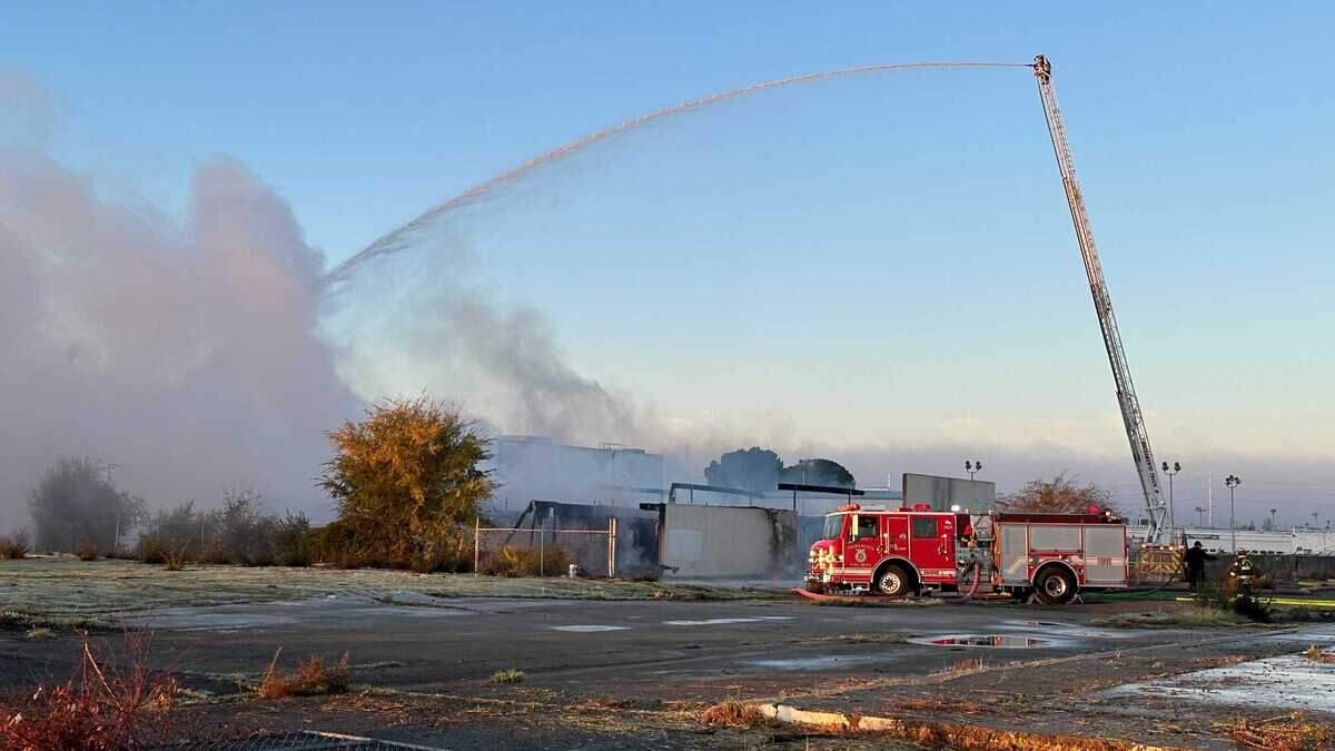 Firefighters work to suppress flames using a ladder truck after a two-alarm blaze broke out on the 3800 block of Florin Road near Franklin Boulevard on Friday, Dec. 8, 2023. The cause of the fire is under investigation, officials said.