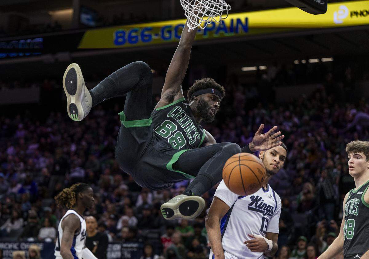 Boston Celtics center Neemias Queta (88) follows through with a slam dunk against Sacramento Kings forward Keegan Murray (13) during an NBA game at Golden 1 center on Thursday.