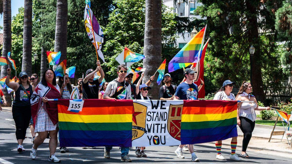 Members of the Sacramento Republic FC display a banner that reads “We stand with you” while walking in the Sacramento Pride March on June 15, 2025.