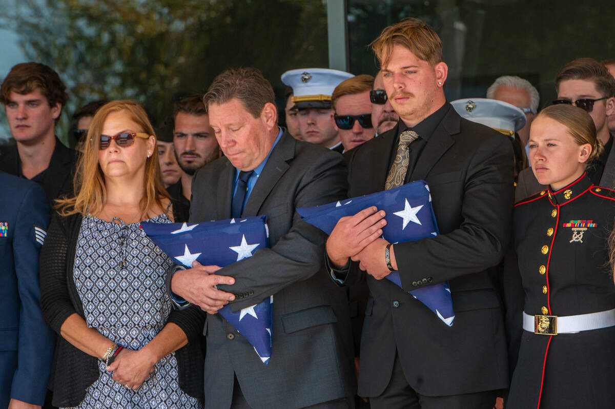 12. After the service for fallen Marine Sgt. Nicole Gee, her father Richard Herrera, left, and husband Jarod Gee, right, hold flags as her casket is moved to hearse at Bayside Church’s Adventure Campus in Roseville on Saturday Sept. 18, 2021. Sgt. Gee lost her life, along with 12 other U.S. service members, in the bombing attack at the Kabul airport on Aug. 26.
