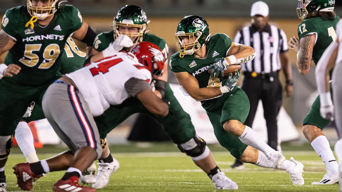 Sacramento State running back Cameron Skattebo (4) takes a handoff and runs downfield against Utah Tech during the first quarter of the NCAA college football game Saturday, Sept. 3, 2022, at Hornet Stadium in Sacramento.
