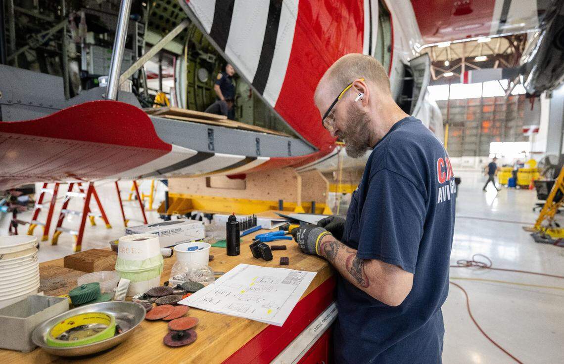 Cal Fire’s Ron Porten sands a part for a C-130H air tanker on Thursday at McClellan Airport as work is being completed on one of seven tankers.
