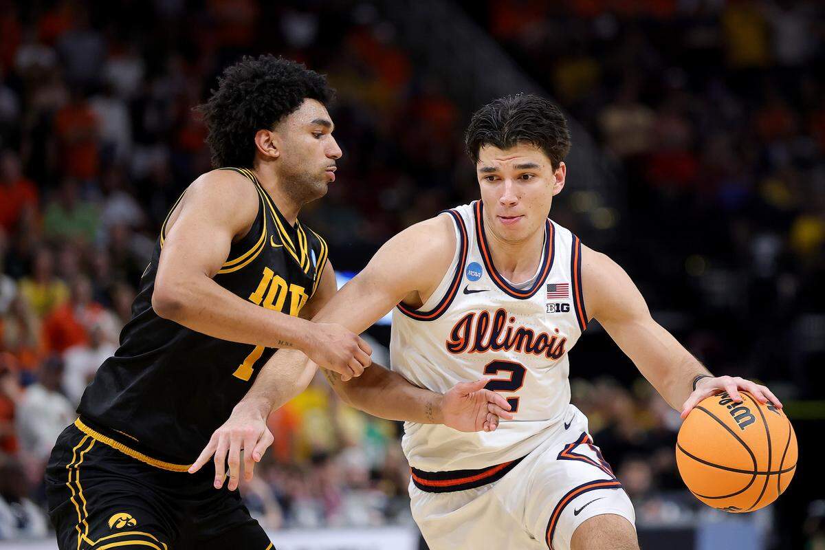 Andrej Stojakovic of the Illinois Fighting Illini drives to the basket against Kael Combs of the Iowa Hawkeyes during the second half in the Elite Eight of the 2026 NCAA Men's Basketball Tournament at Toyota Center on Saturday, March 28, in Houston.