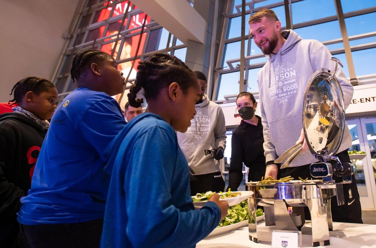 Sacramento Kings center Domantas Sabonis serves children with the Roberts Family Development Center attending the “Eat Like a King” event Wednesday.
