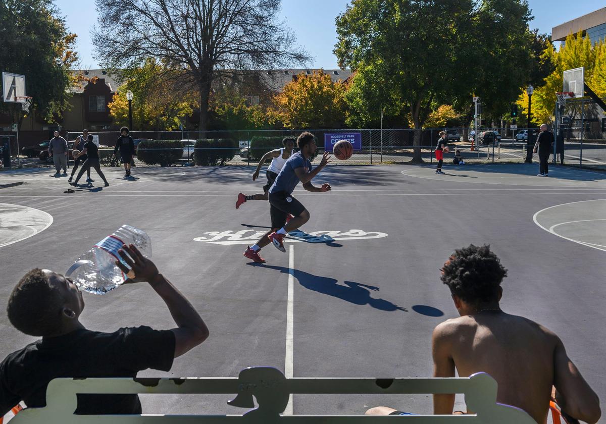 Members of the community come together to play pickup basketball at Roosevelt Park, Sunday, Nov. 3. The pinnacle of competitive outdoor Sacramento basketball is often found there.
