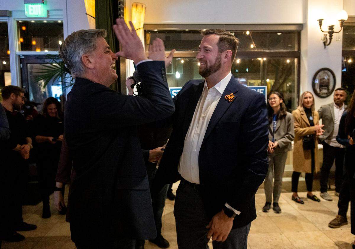 Sacramento City Council District 4 candidate Phil Pluckebaum, left, high-fives Sacramento mayoral candidate Steve Hansen during his election party at Zocalo in Sacramento on Tuesday.
