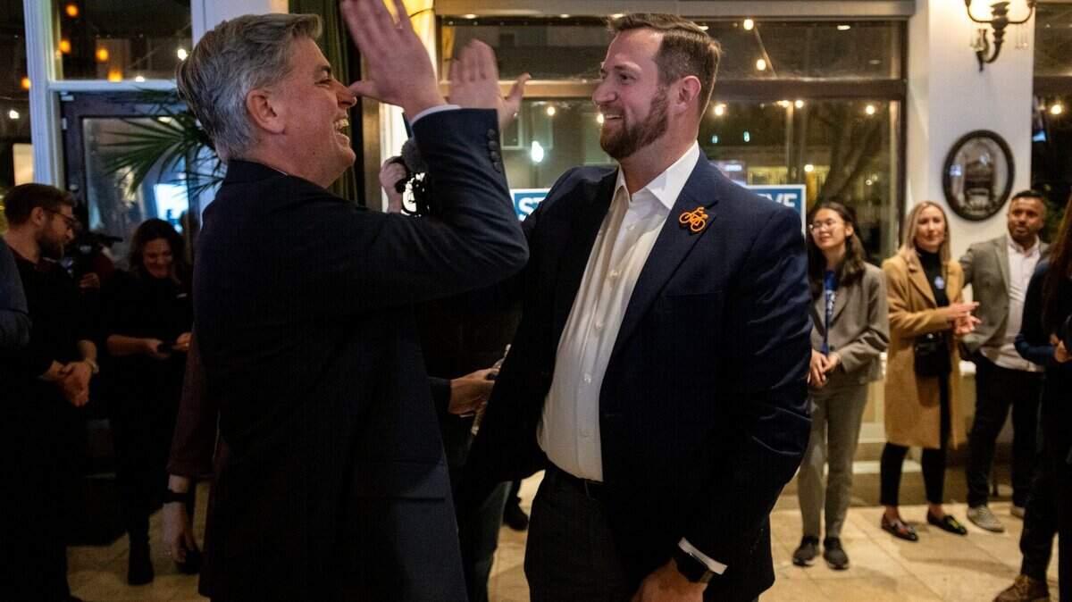 Sacramento City Council District 4 candidate Phil Pluckebaum, left, high-fives Sacramento mayoral candidate Steve Hansen during his election party at Zocalo in Sacramento on Tuesday, March 5, 2024.