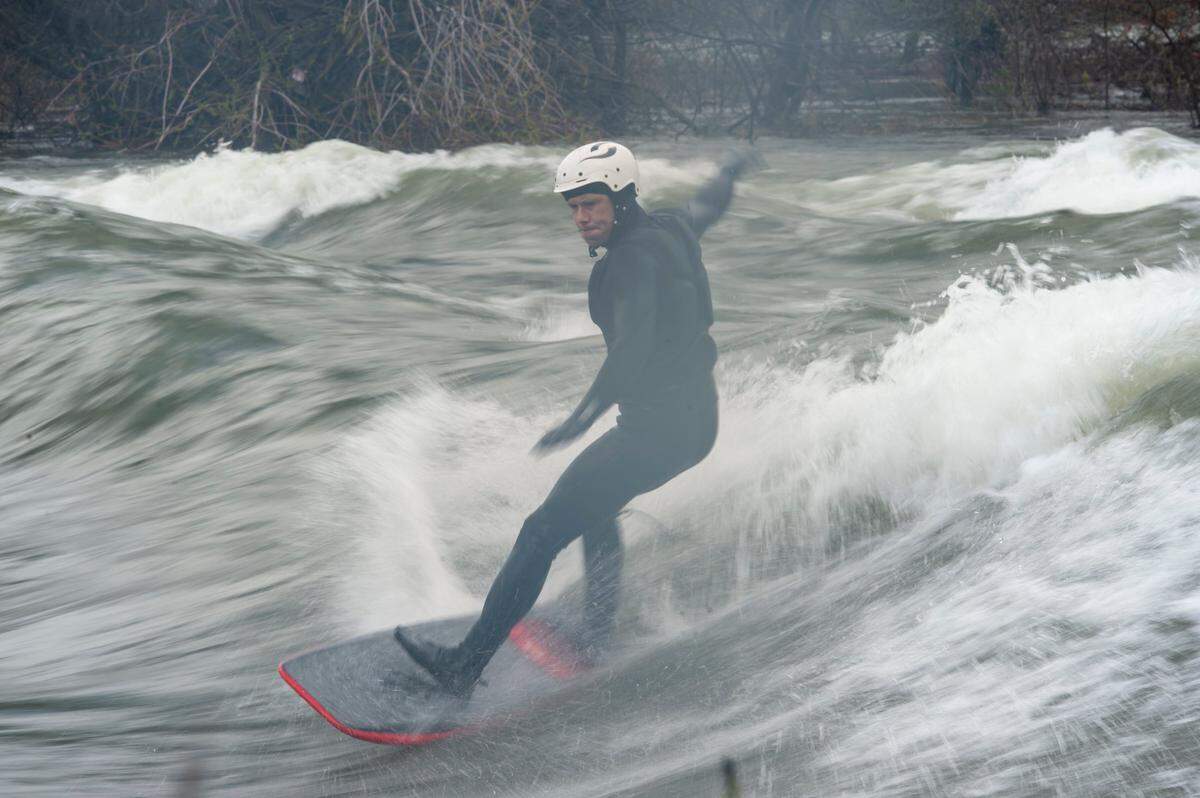 Tyler Lausten carves a wave while river surfing on Sunday, March 12, 2023, at the American River in Carmichael.