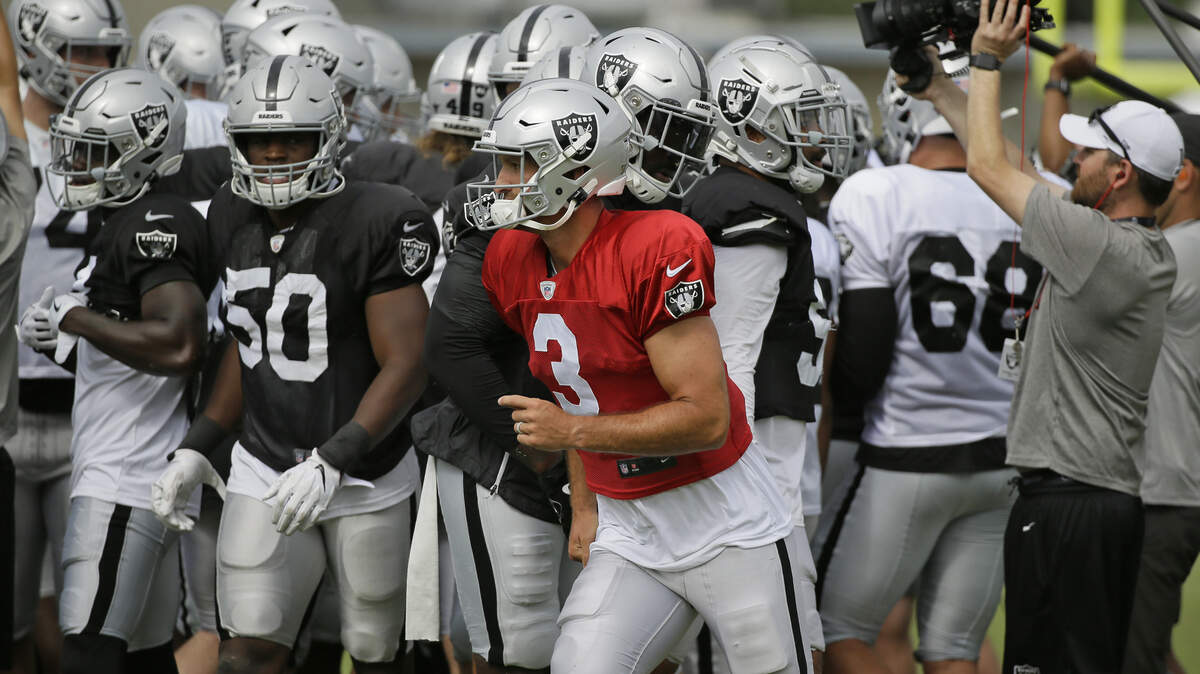 Oakland Raiders quarterback Nathan Peterman breaks away from a team huddle during training camp Monday.