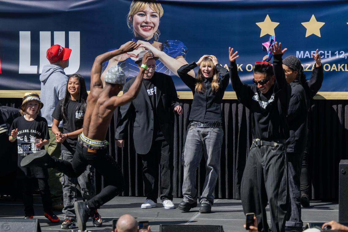 Olympic gold medalist Alysa Liu dances and take the stage with TurfInc Dancers during a rally celebrating her at Frank Ogawa Plaza in Oakland on Thursday. Thousands came out to honor Liu for her success at the 2026 Milan Cortina Olympics.