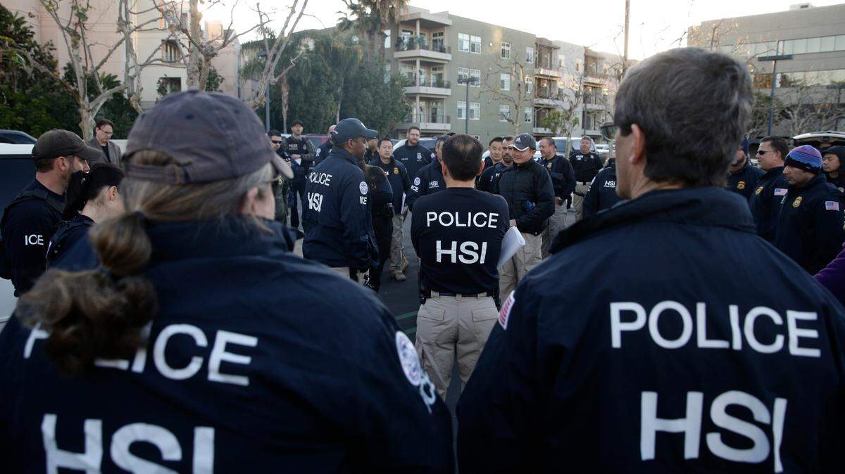 Federal agents gather at a parking lot near an upscale apartment complex, Tuesday, March 3, 2015, in Irvine, Calif. Shortly after sunrise, federal agents swarmed the complex in the Orange County where authorities say a birth tourism business charged pregnant women $50,000 for lodging, food and transportation. The key draw for travelers is that the United States offers birthright citizenship. (AP Photo/Jae C. Hong)