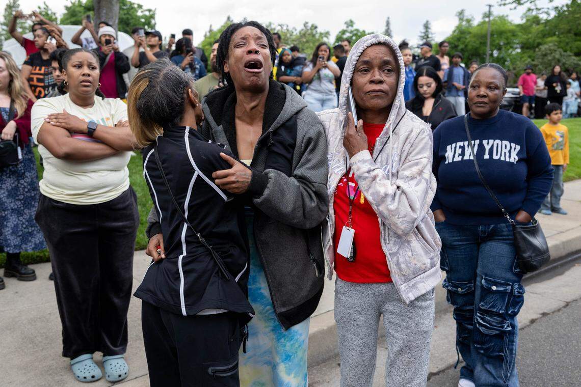 Family members of the shooting suspect call for him as law enforcement officers demand his surrender after a shooting at Natomas High School that left one student dead on Friday, April 10, 2026. Authorities searched for the suspect at the Natomas Village apartments near the campus.