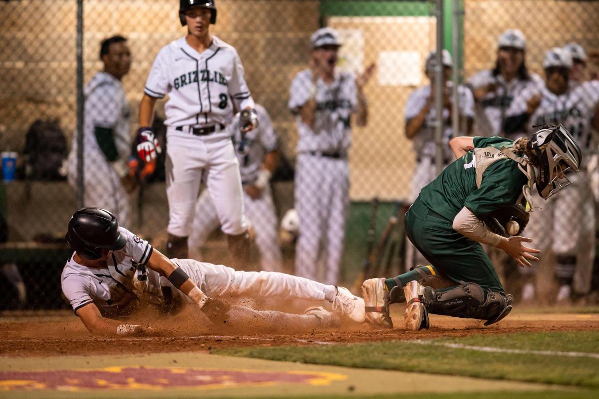 Granite Bay’s Evan Bishop, left, slides past Rio Americano catcher Jake Marr to score on a double hit by Jacob Garcia during the second inning of the Sac-Joaquin Section Division II championship high school baseball game Tuesday, May 24, 2022, at Sacramento City College.
