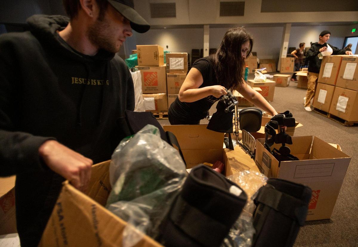 Volunteers Ryland Warren and Olesea Iasnitcai sort and repackage medical supplies at the House of Bread Church in Orangevale on March 22 for the Ukraine relief effort. The church was able to collect and donate six semi-truck loads of supplies on the first day of their relief effort.
