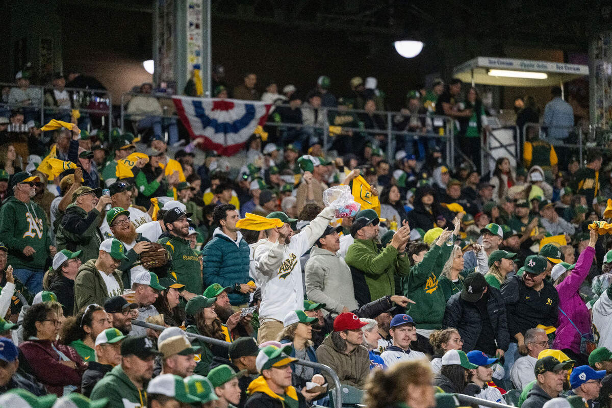 Fans raise their rally towels during the first Major League Baseball game at Sutter Health Park in West Sacramento on Monday.