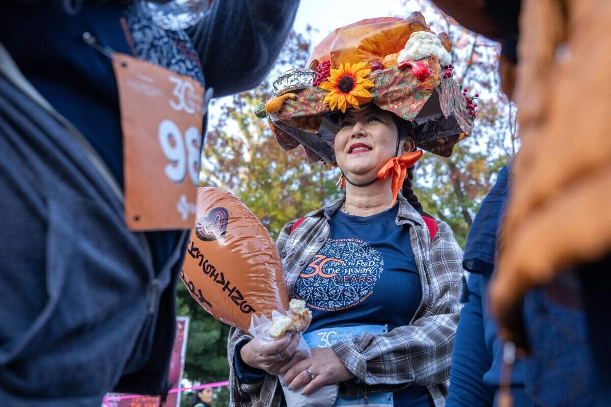 Hillary Sunada of Sacramento wears a turkey hat, made by a friend, during the 30th annual Run to Feed the Hungry on Thursday in East Sacramento.