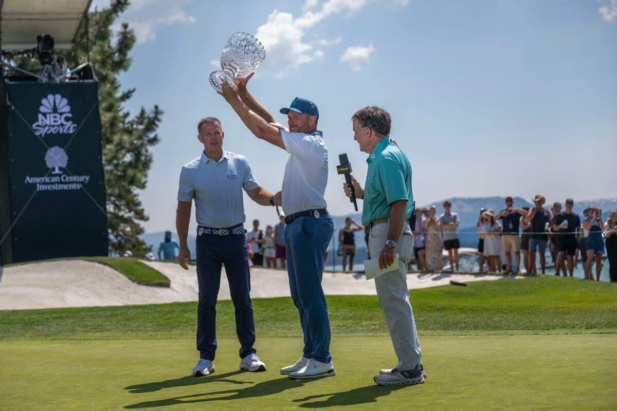 Former NHL All Star Joe Pavelski raises the championship trophy after winning the American Century Championship celebrity golf tournament at Edgewood Tahoe Resort in Stateline, Nev., on Sunday, July 13, 2025.