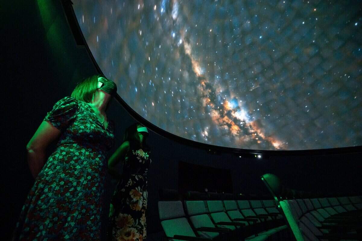 Michele Wong, left, executive director of the SMUD Museum of Science and Curiosity and Shahnaz Van Deventer, director of marketing and development, look up at a projection inside the museum’s planetarium on Sept. 9.