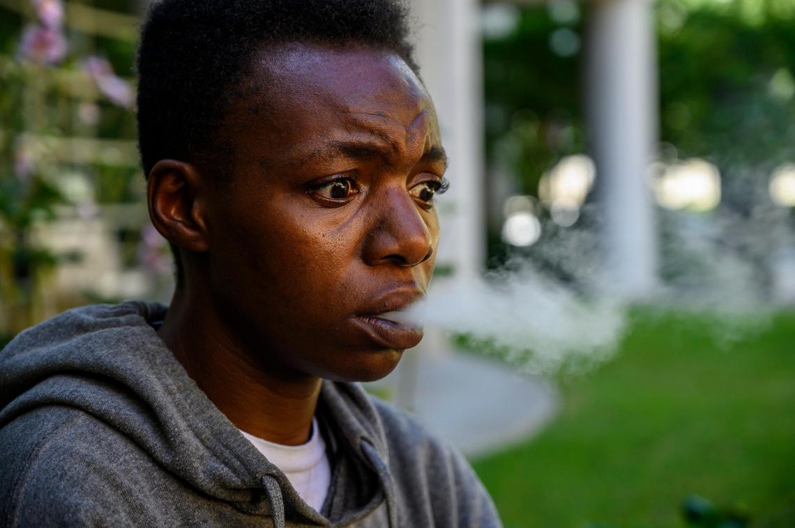 Tajia Thelusma, 30, smokes from a vaping pipe, as she talks about the struggles of living in her car on Friday, July 19, 2019, in Sacramento.