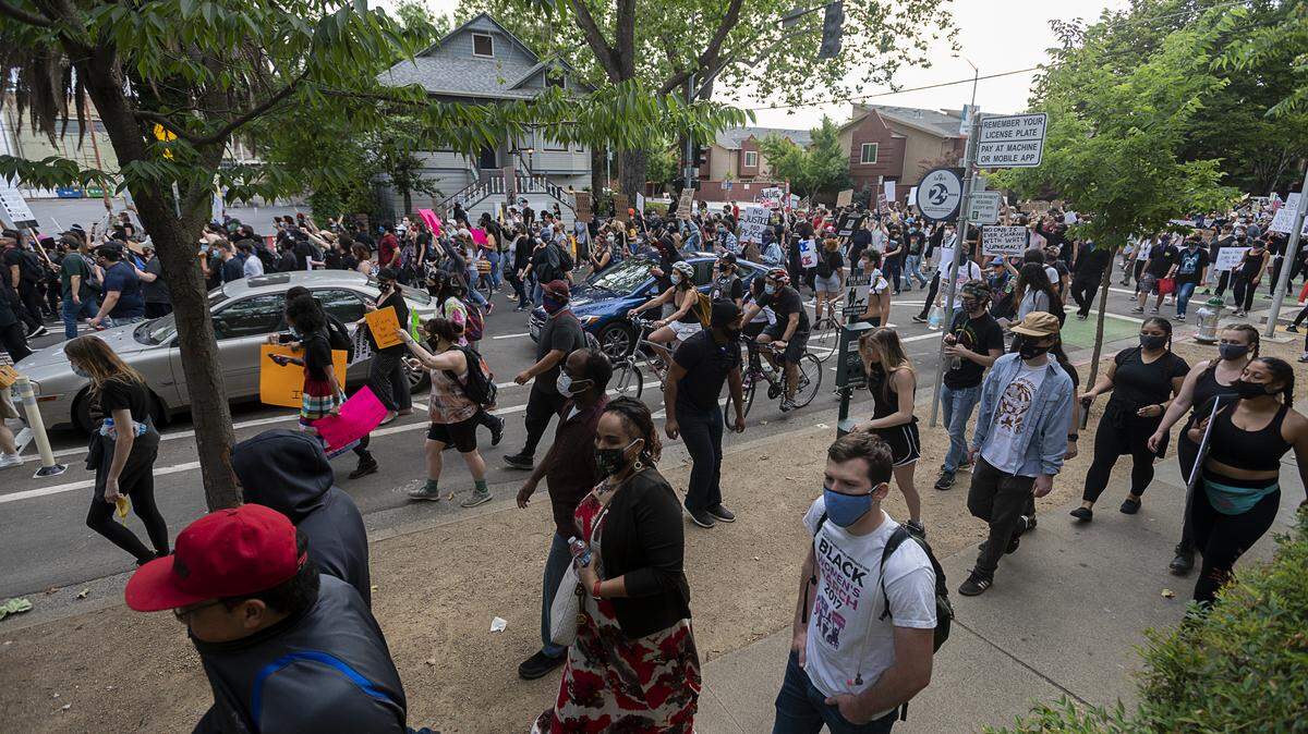 Demonstrators walk down P Street toward the Capitol during a protest over the death of George Floyd on Sunday in Sacramento. Floyd died while under Minneapolis police custody May 25.