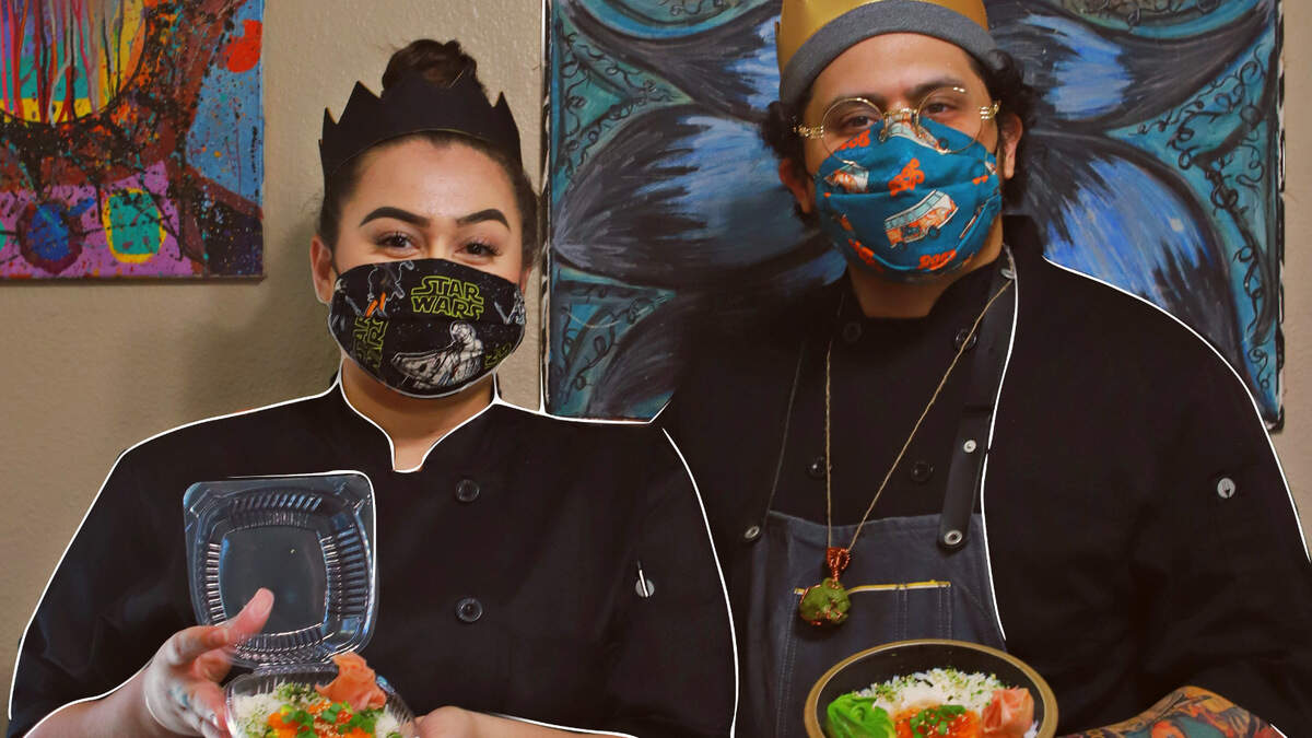 JD and Amber Snead hold up their poke dishes, which are part of the Michelin Minivan’s menu rotation. JD Snead began the food delivery service after the pandemic cost him his restaurant job.