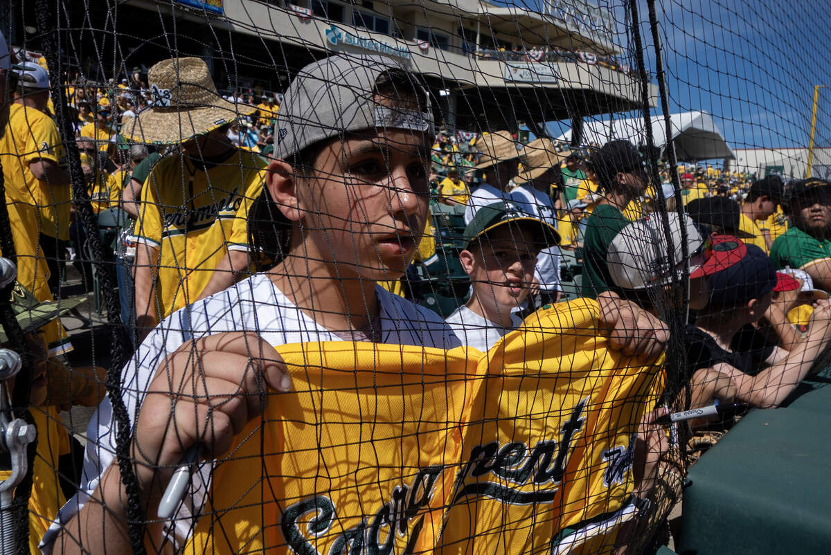 Rocco Sansieir, visiting from New Jersey try to get a players autograph before the Athletics played the Houston Astros on Saturday, April 4, at Sutter Health Park in West Sacramento.