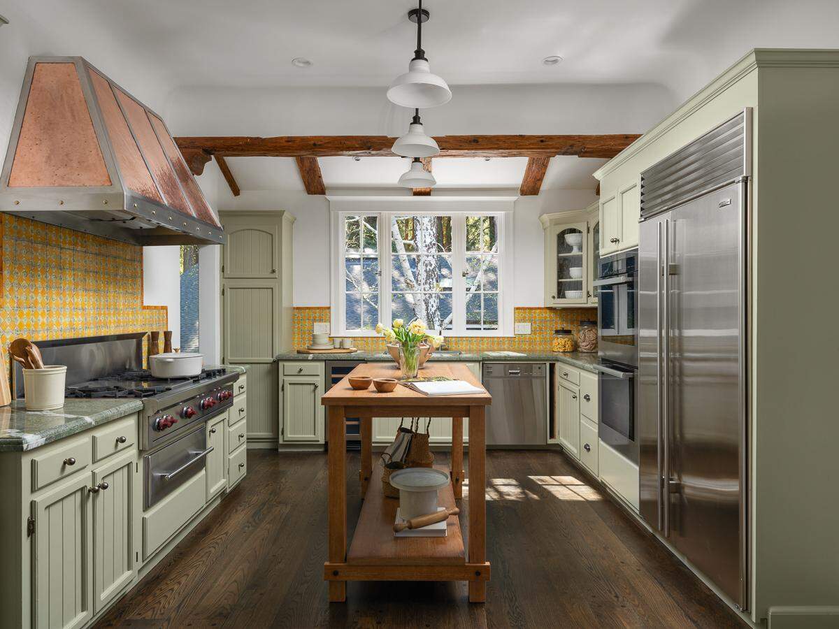 The kitchen is outfitted with Sub-Zero refrigerator and freezer, a built-in wine fridge, Miele ovens, a Wolf range with six burners, a barbecue grill and a warming drawer.