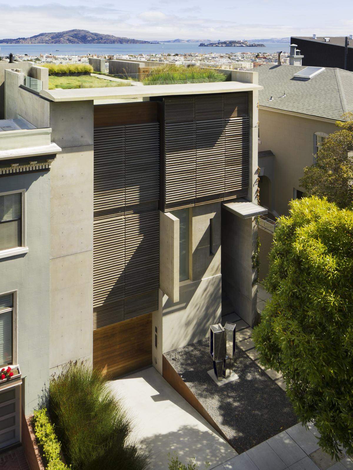 A striking facade of poured-in-place concrete, wood louvers and glass opens to a magnificent great room with soaring 20’ ceilings, skylight and sweeping vistas spanning the Golden Gate and Palace of Fine Arts to Alcatraz and hills of Marin, and beyond.