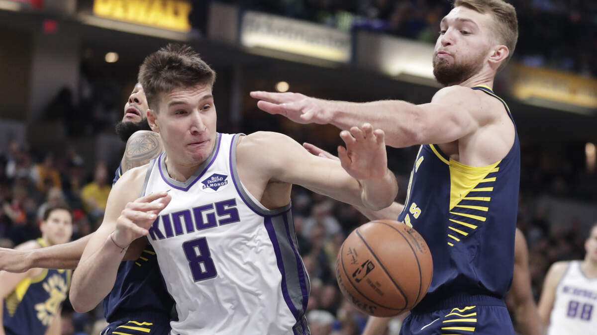 Indiana Pacers forward Domantas Sabonis (11) and Sacramento Kings guard Bogdan Bogdanovic (8) go for a rebound during the first half of an NBA basketball game in Indianapolis, Saturday, Dec. 8, 2018.
