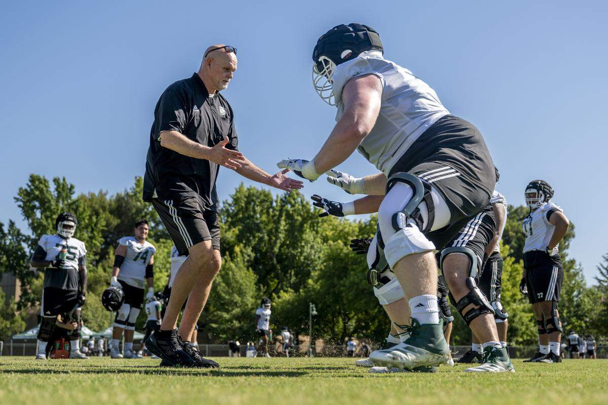 Kris Richardson, Sacramento State's offensive line coach, leads a drill during the first practice of the 2025 season in Sacramento on Friday, August 1, 2025.