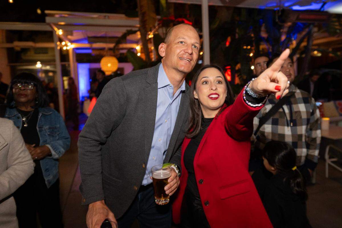 Sacramento mayoral candidate Kevin McCarty and City Councilwoman Karina Talamantes look at the release of the early election returns, which showed him leading Flojaune Cofer, at his election night party on Tuesday, Nov. 5, 2024, at Cafeteria 15L in downtown Sacramento.