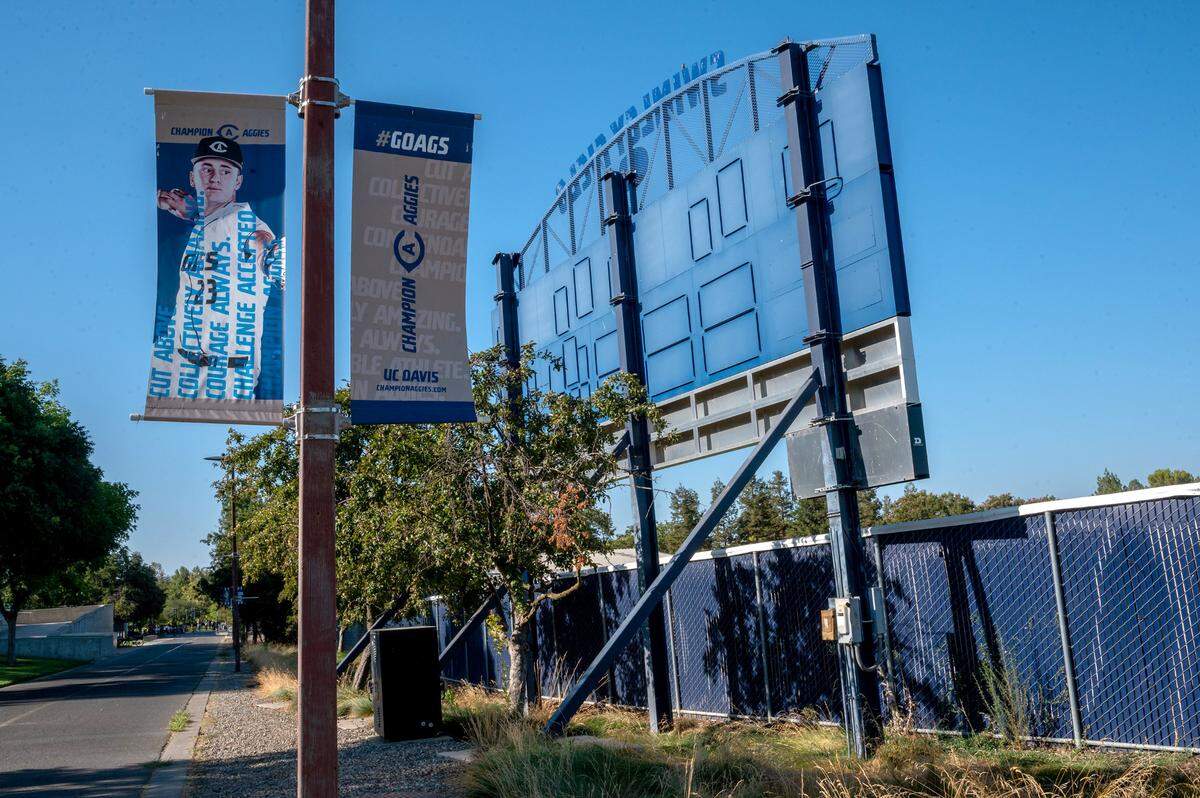 A poster displays a UC Davis baseball player outside the locked Swimley Field on campus in July after the school’s baseball program was been suspended after an investigation found a culture of hazing. The coach later resigned.