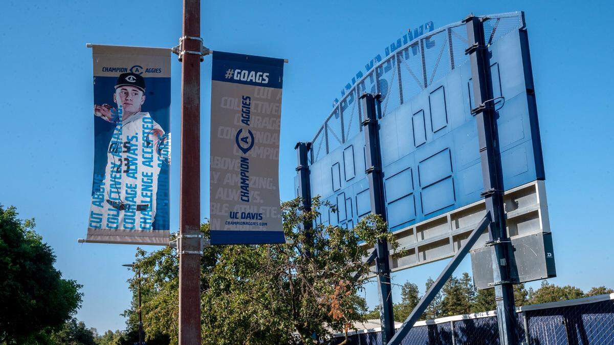 A poster displays a UC Davis baseball player outside the locked Swimley Field on campus on Thursday, July 15, 2021. The school’s baseball program has been suspended, and its coaches placed on leave, by the school’s athletic department.