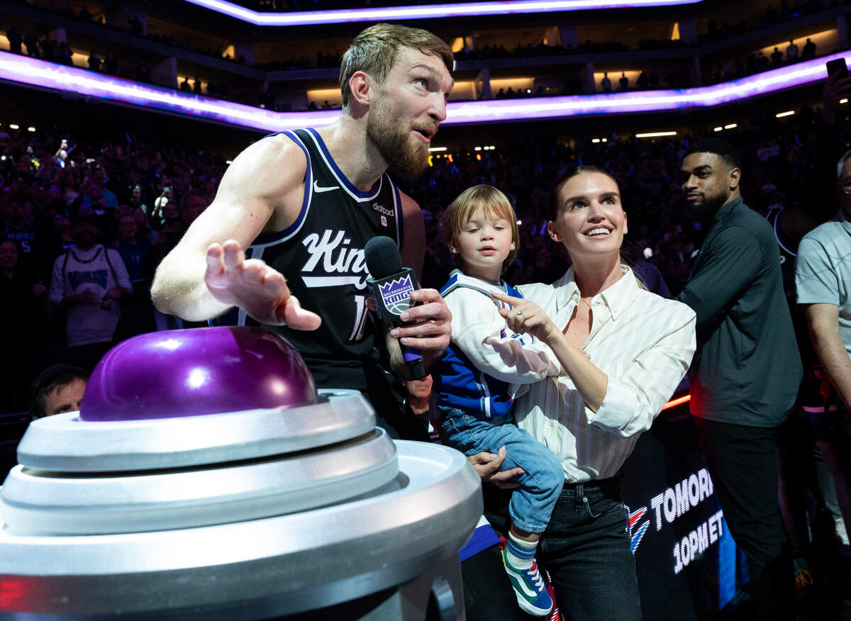 Sacramento Kings forward Domantas Sabonis (10), with his wife Shashana and son Tiger, lights the beam after the Sacramento Kings beat the Los Angeles Lakers 120-107 at Golden 1 Center on March 13.