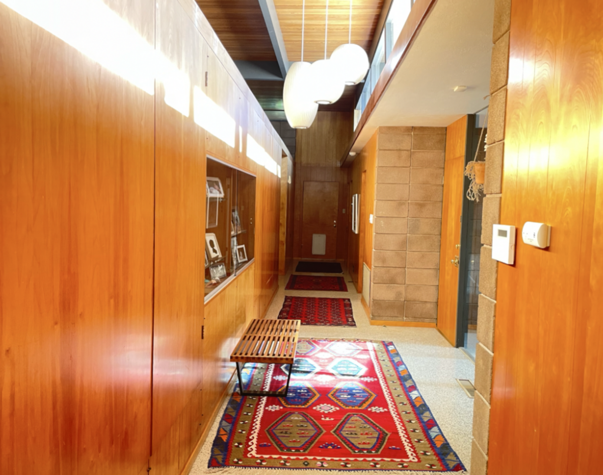 The long hallway runs from the children’s wing of the house, past the entryway and to the primary bedroom.