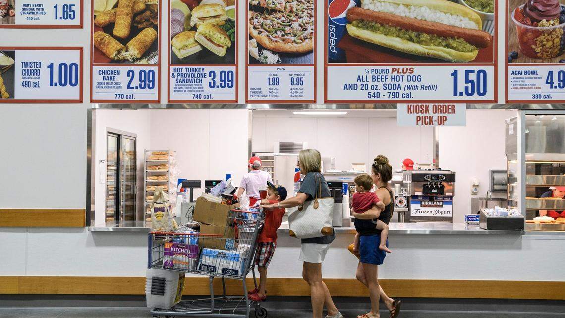 Jaxon Stern, 4, from left, Nicole Toone, Sawyer Stern, 2, and Victoria Stern order lunch at Costco's food court while shopping in the new Evansville store, Friday, June 28, 2019. They ordered a few "famous" $1.50 hot dogs. 

Costco Opening 18