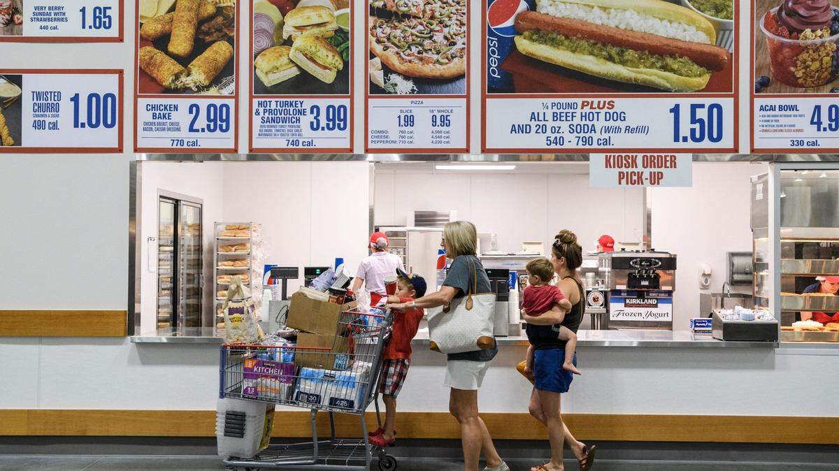 Jaxon Stern, 4, from left, Nicole Toone, Sawyer Stern, 2, and Victoria Stern order lunch at Costco's food court while shopping in the new Evansville store, Friday, June 28, 2019. They ordered a few "famous" $1.50 hot dogs. 

Costco Opening 18