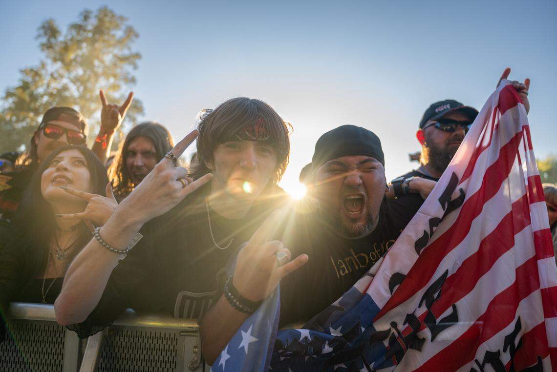 Texas buddies Parker Reeves and Leo Vargas waive their American flag between performances during the Aftershock festival on Friday, Oct. 3, 2025, in Discovery Park in Sacramento. 