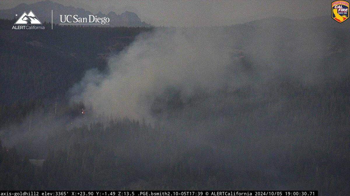 Flames and smoke from the Dutch Fire are visible in Cal Fire surveillance cameras near Gold Run on Saturday, Oct. 5, 2024. The Dutch Fire, which sparked in Nevada County, has prompted the mandatory evacuation of Dutch Flat in Placer County.