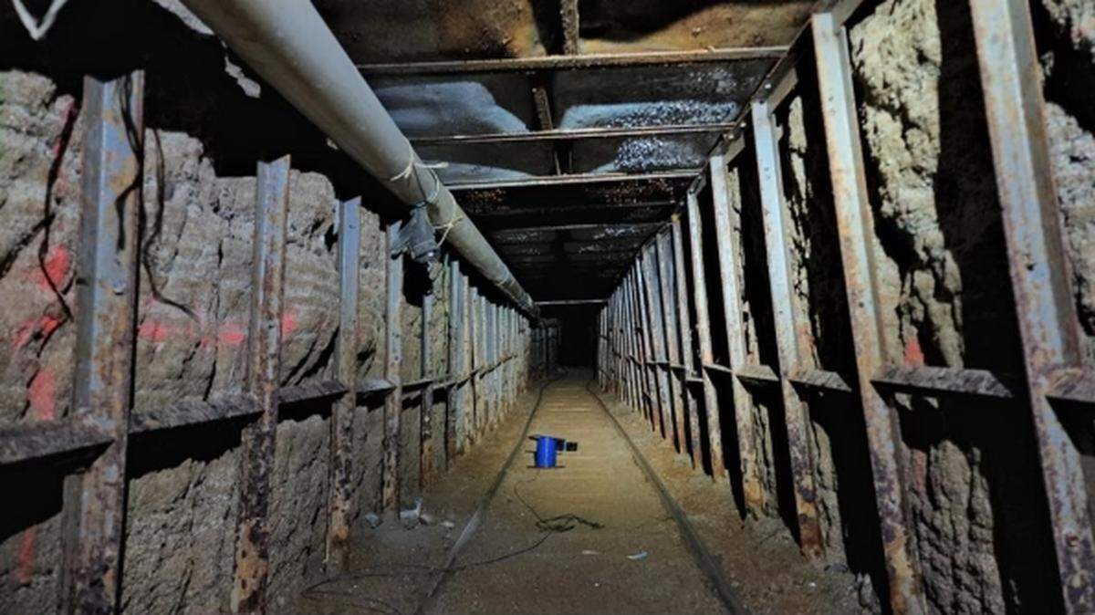 A 1,744-foot long border drug tunnel between Tijuana and a California warehouse has been shut down, federal officials said. Six people face charges.