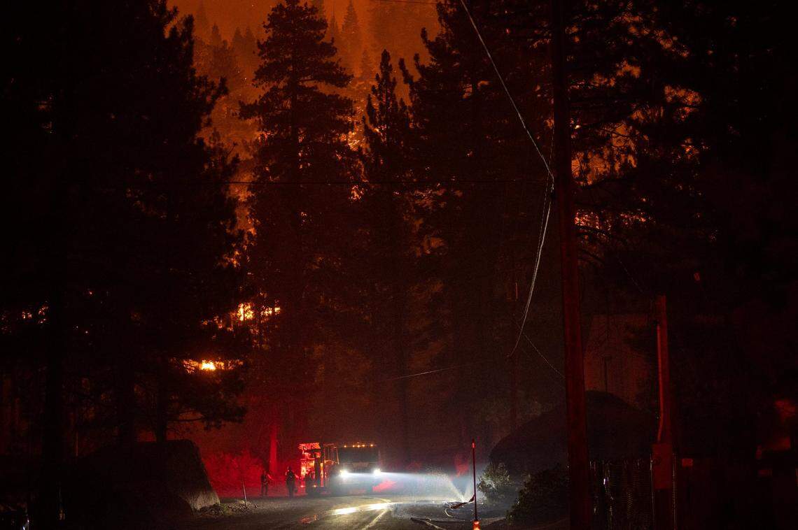 Firefighters protect homes and buildings on Shakori Drive on Monday, Aug. 30, 2021, along Highway 89 in Christmas Valley during the Caldor Fire.